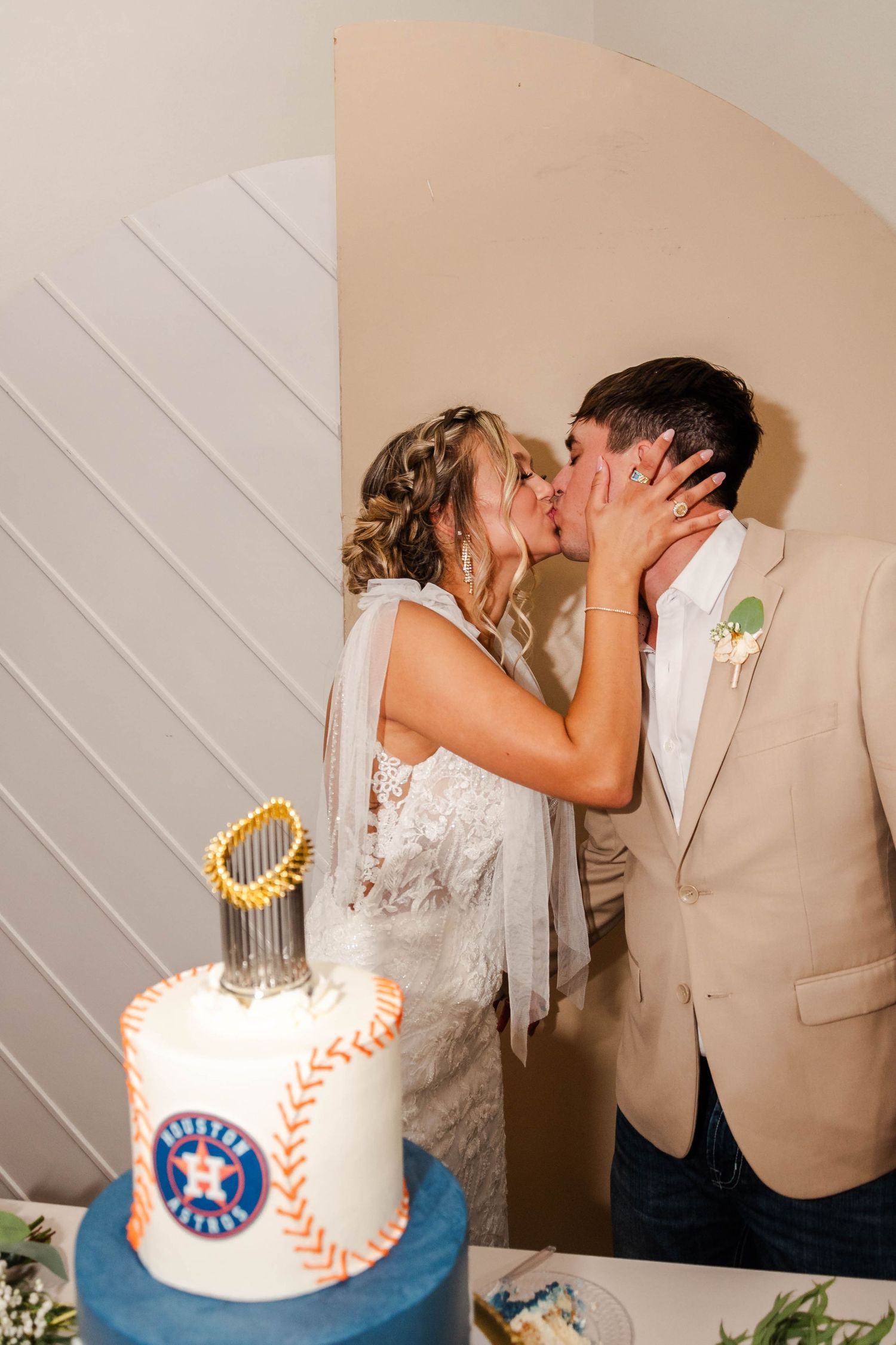 Couple kissing in front of grooms cake by Lottie's Cookies and Cakery