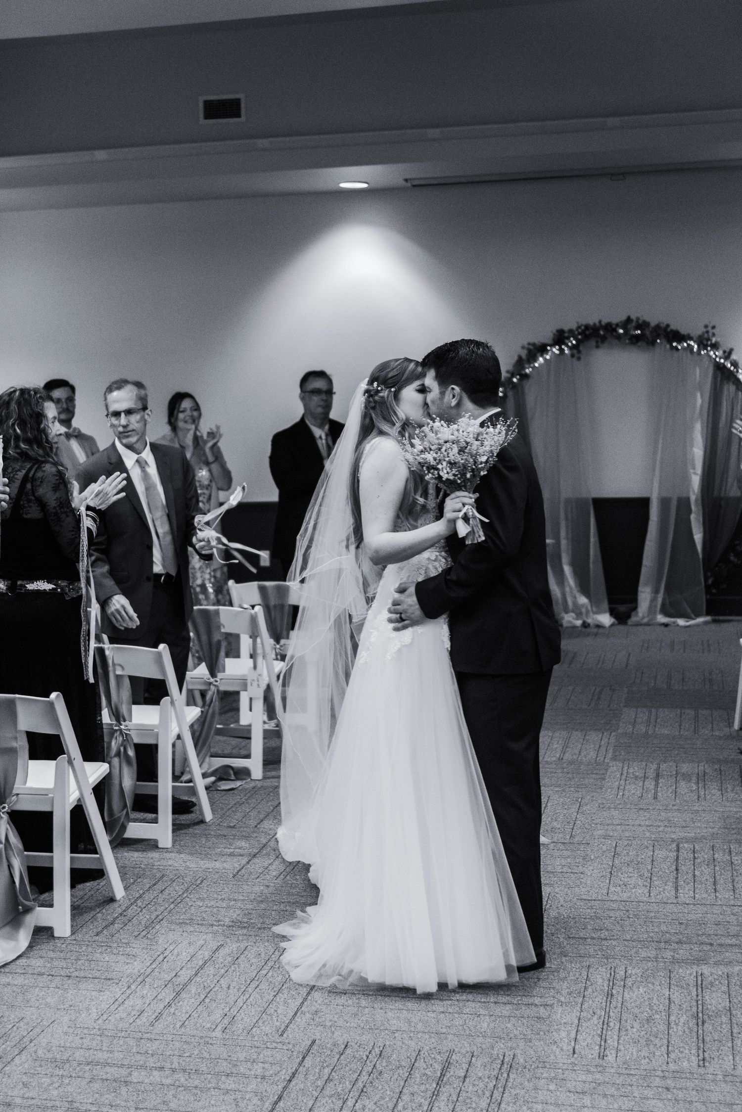An aisle kiss from the bride and groom