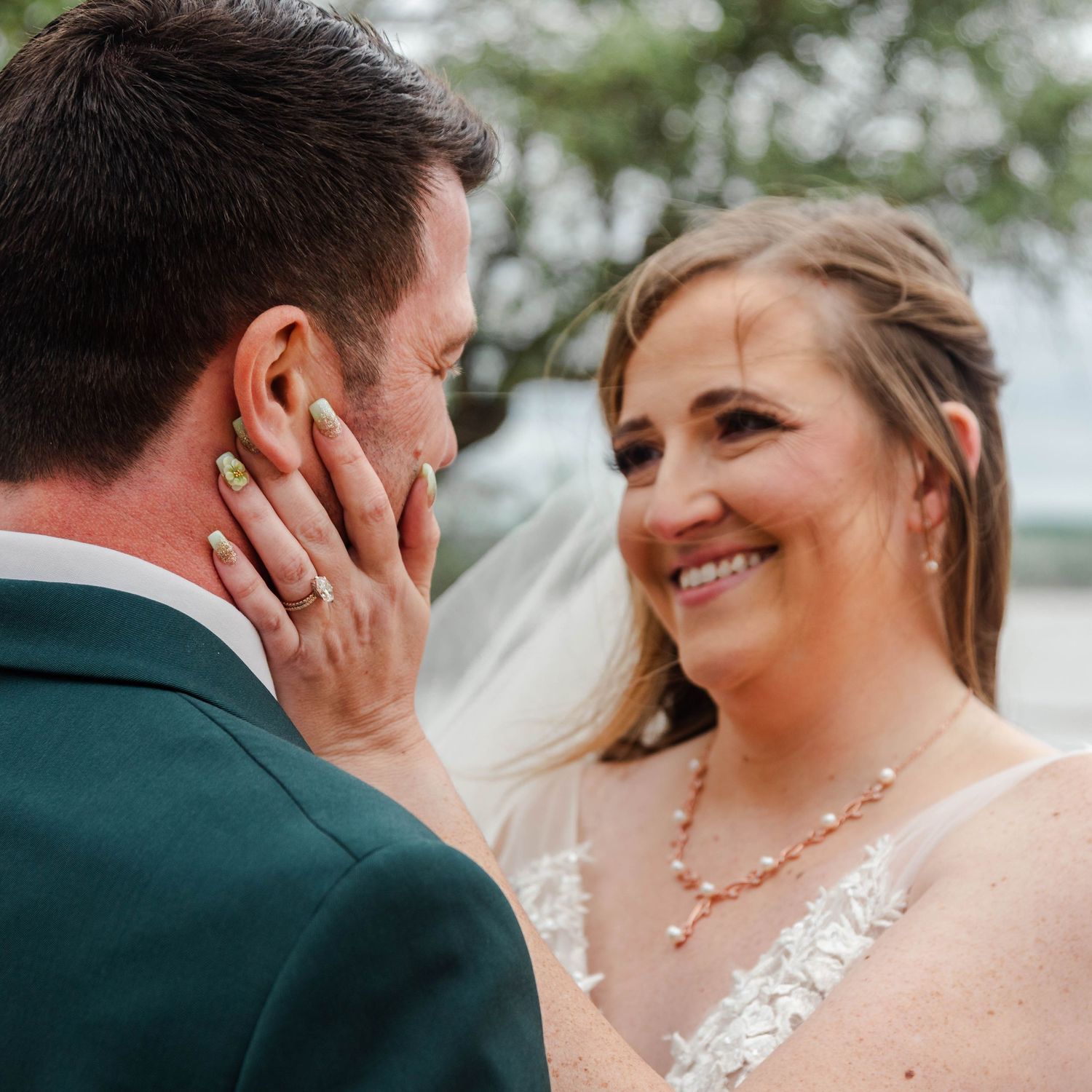 a bride holding the grooms face gently