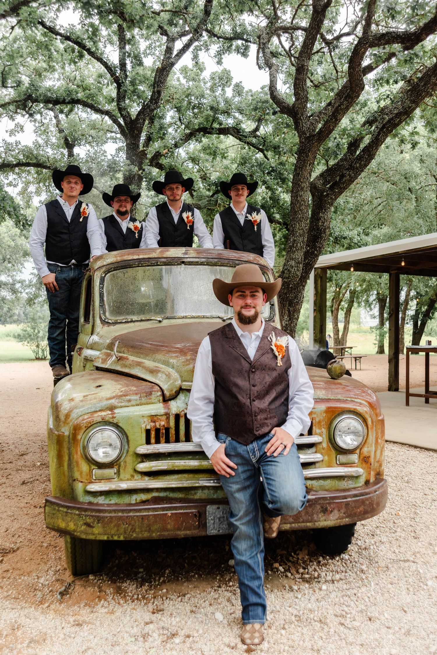 Groom and groomsmen on a truck posing for a wedding