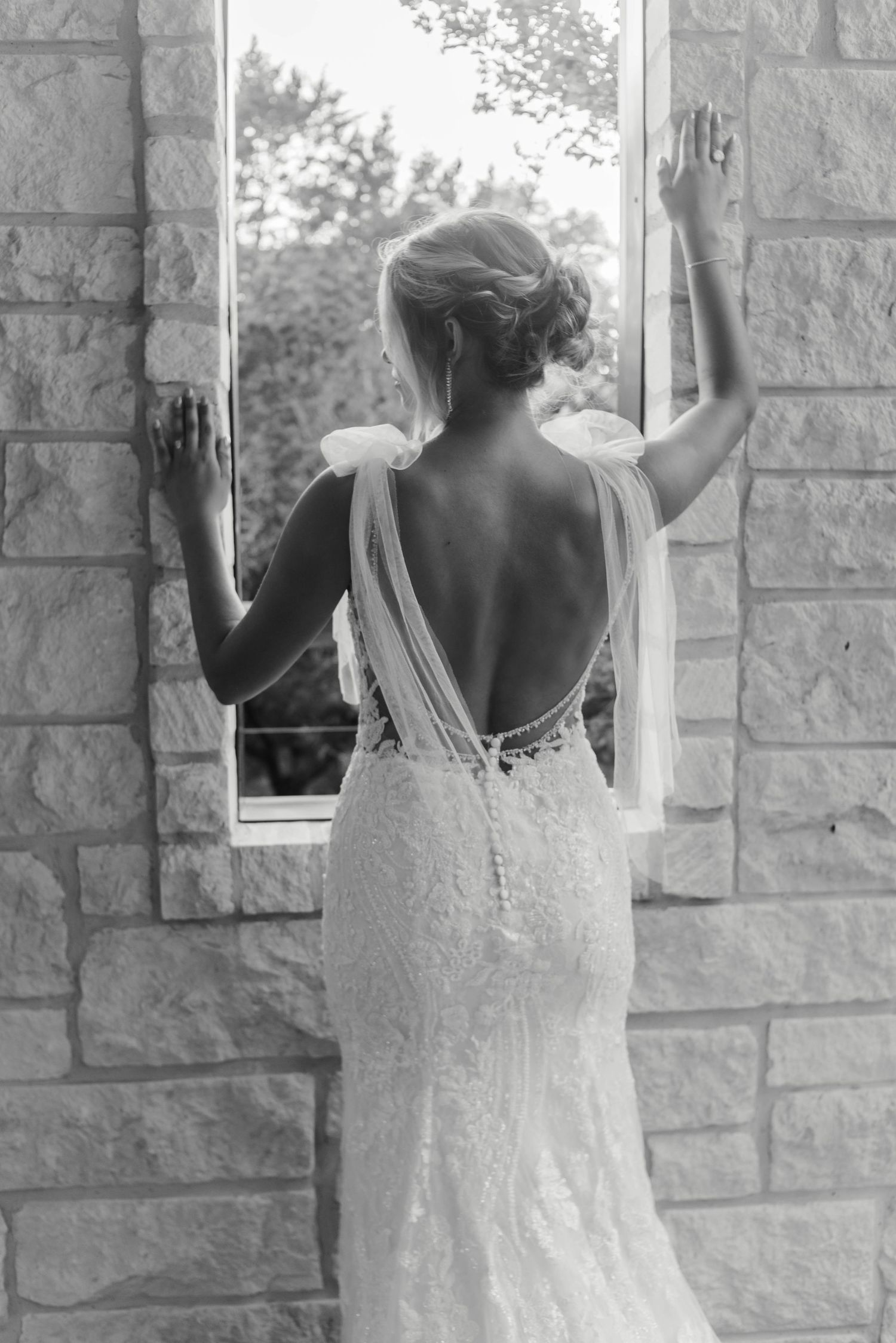 A bride posing at a window at Fossil Creek Retreat