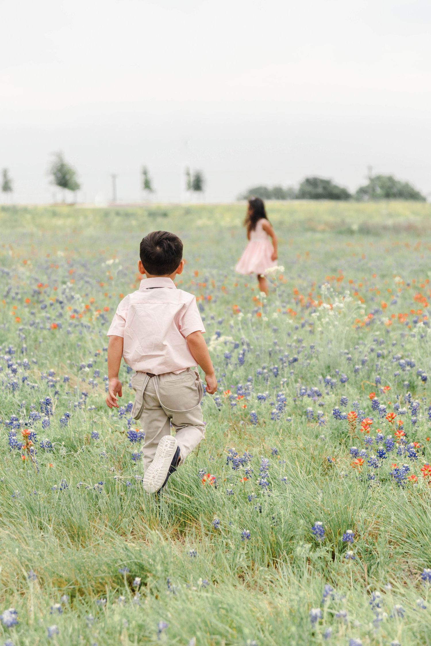children walking in bluebonnets