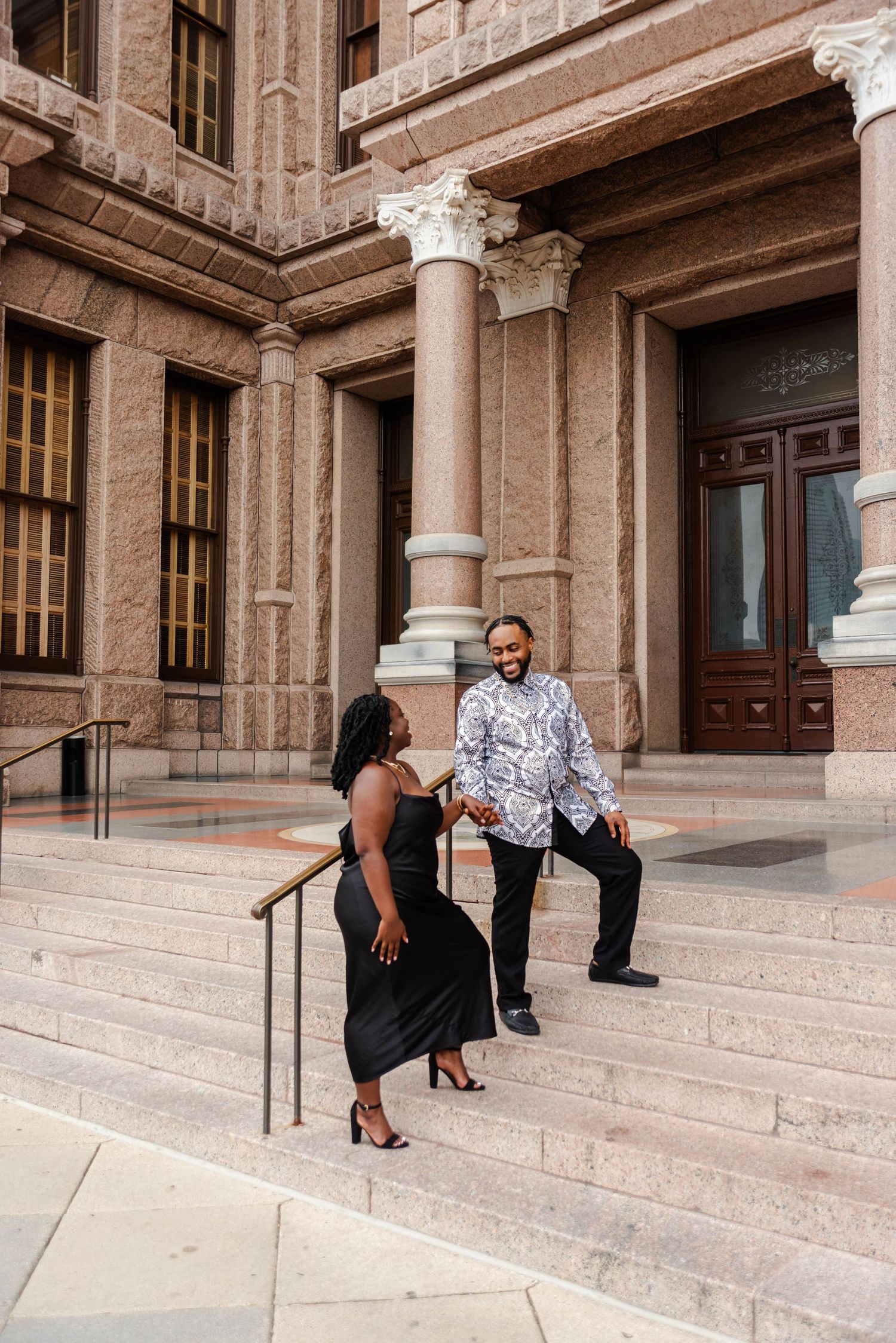 A man leads his woman upstairs toward the state Capitol Building