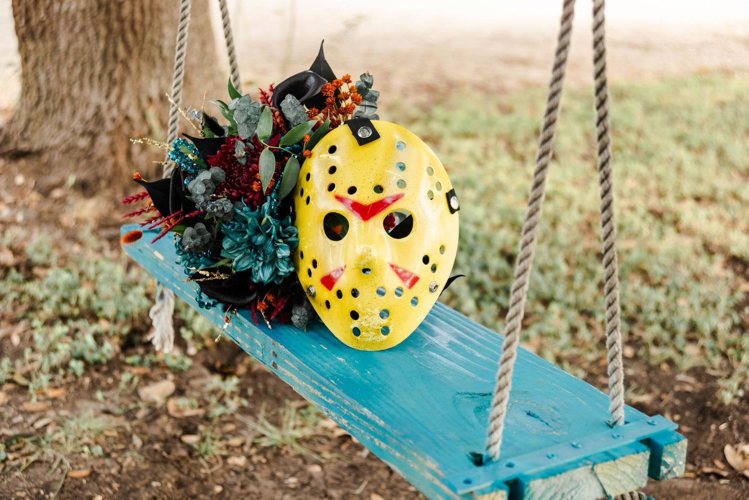 Jason mask with flower bouquet on a swing