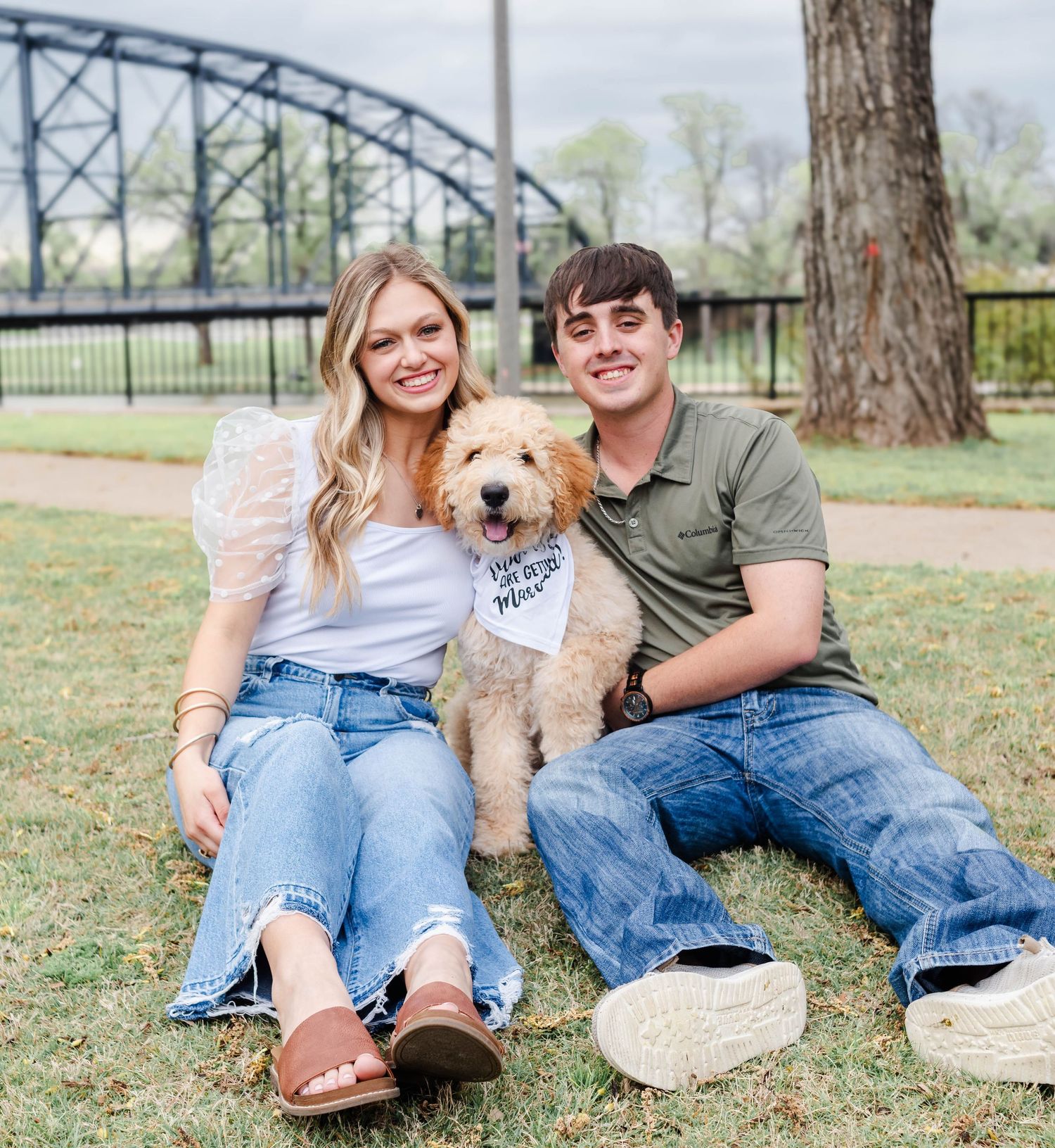 Couple sitting at a park in Waco Texas with their dog.