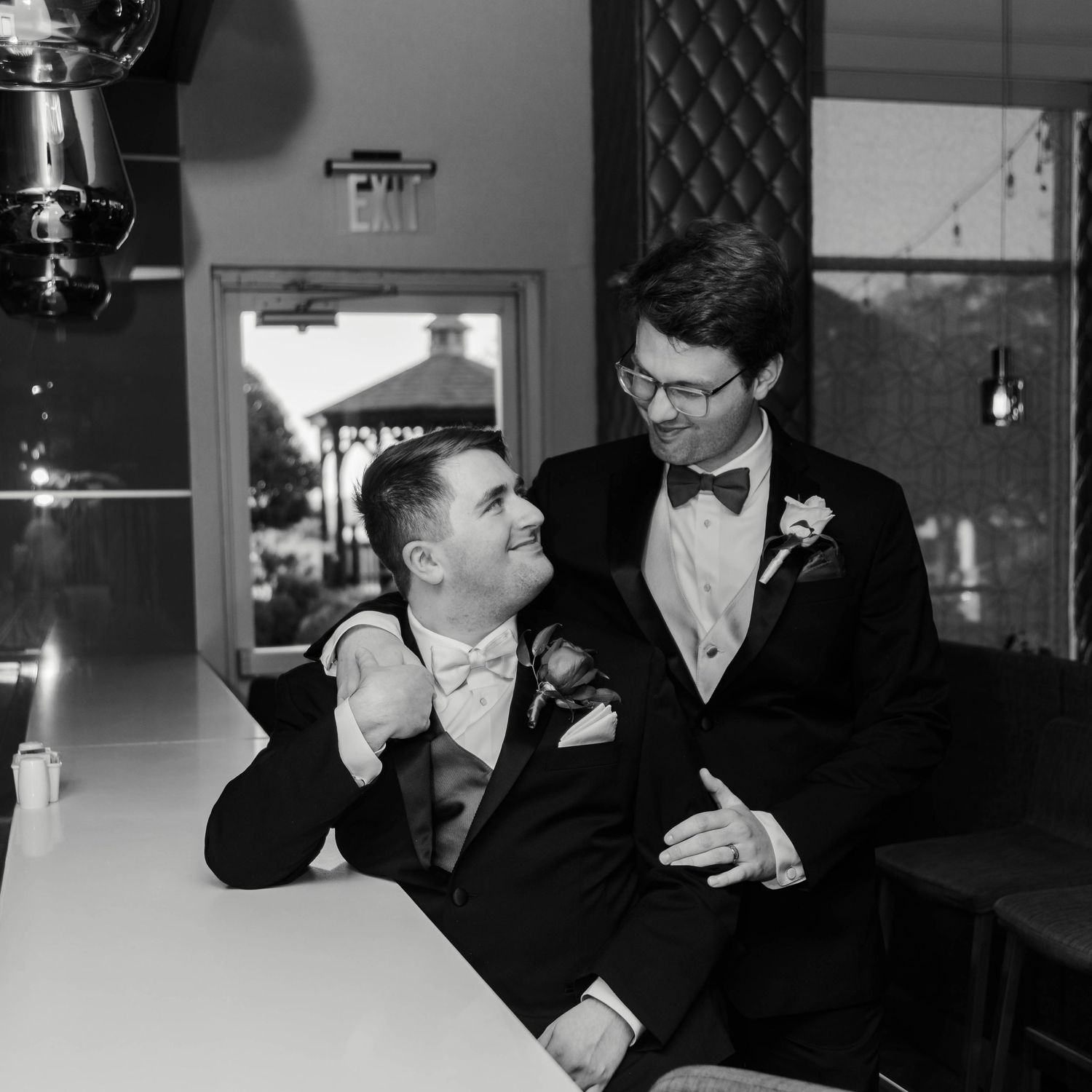 Two men gazing lovingly at each other while holding hands.