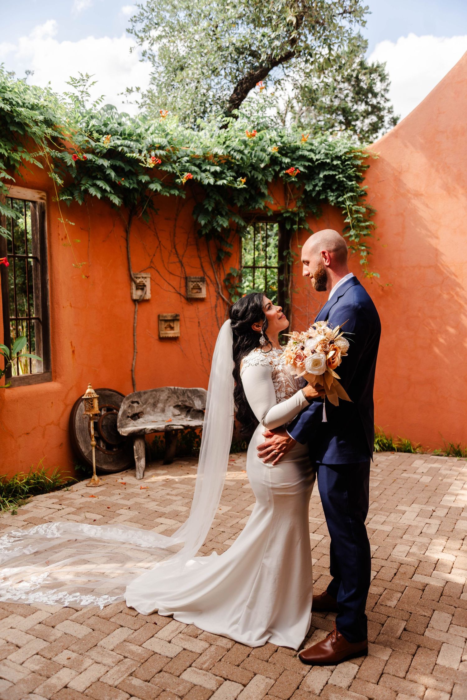 a couple stands looking at each other on their wedding day