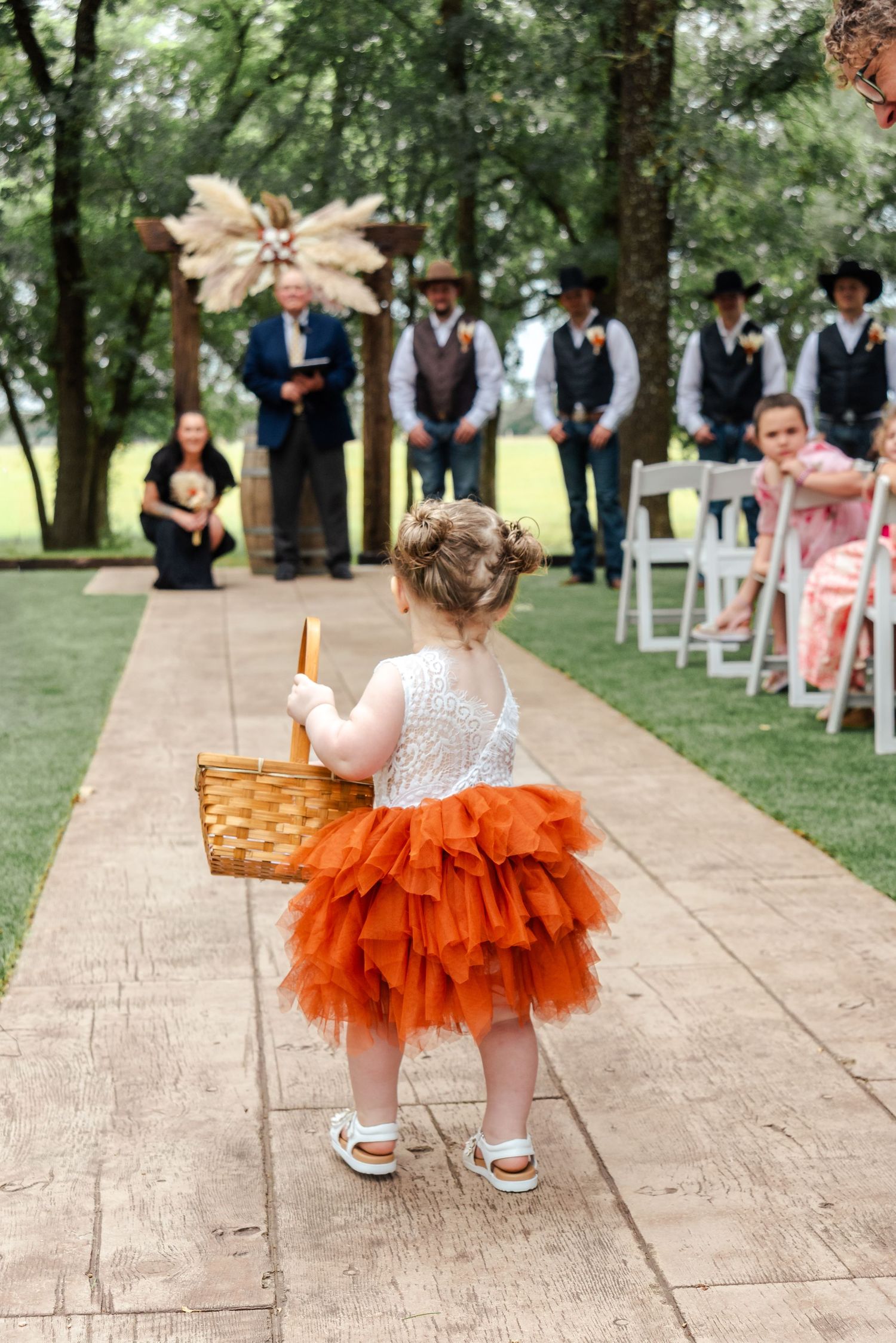 a flower girl walks down the aisle