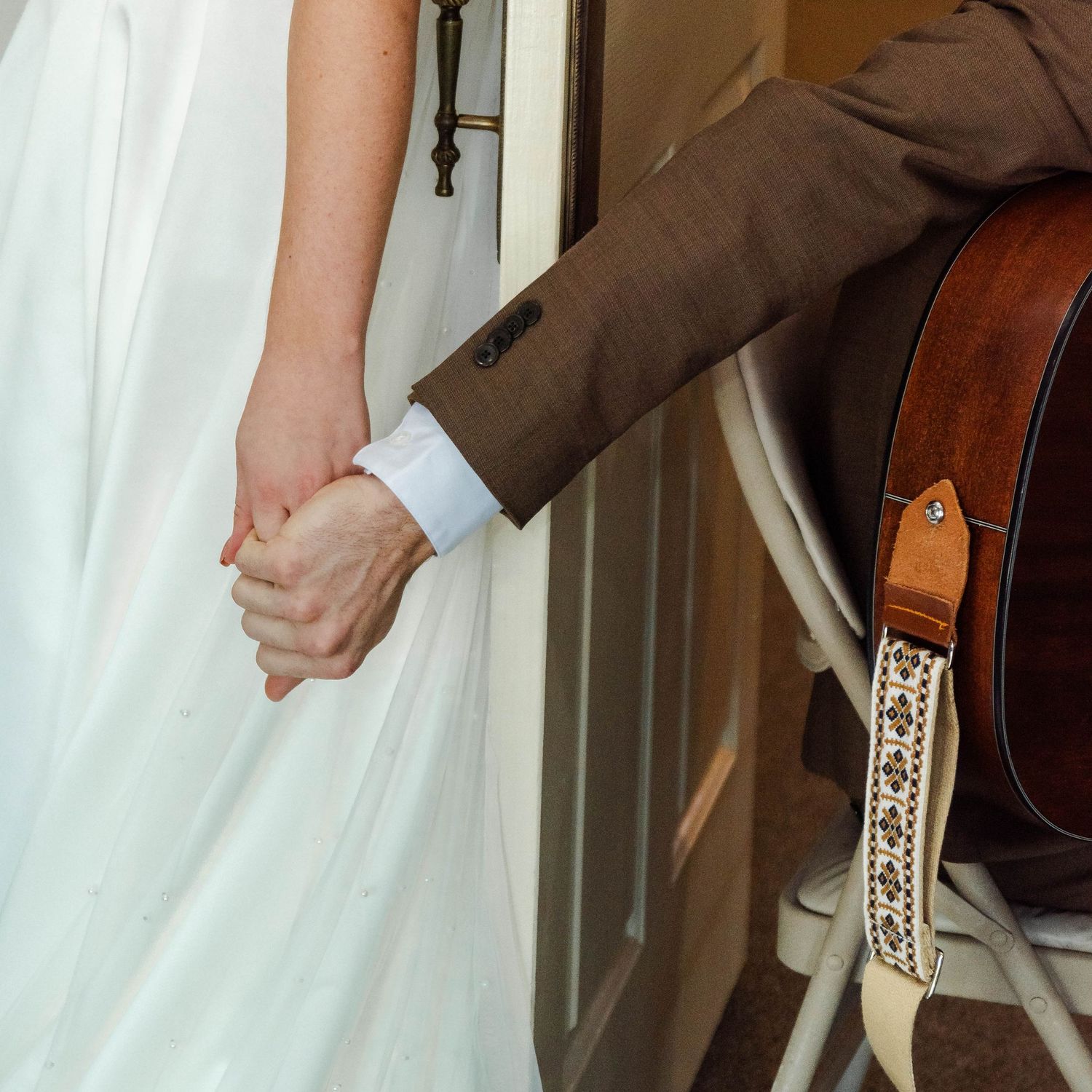 a couples hands touching before their wedding