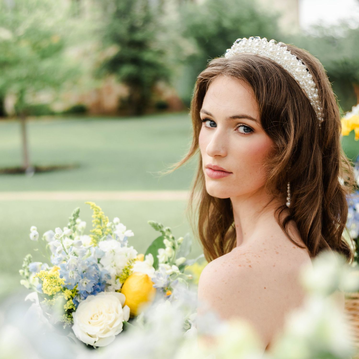 A woman looks softly at the camera