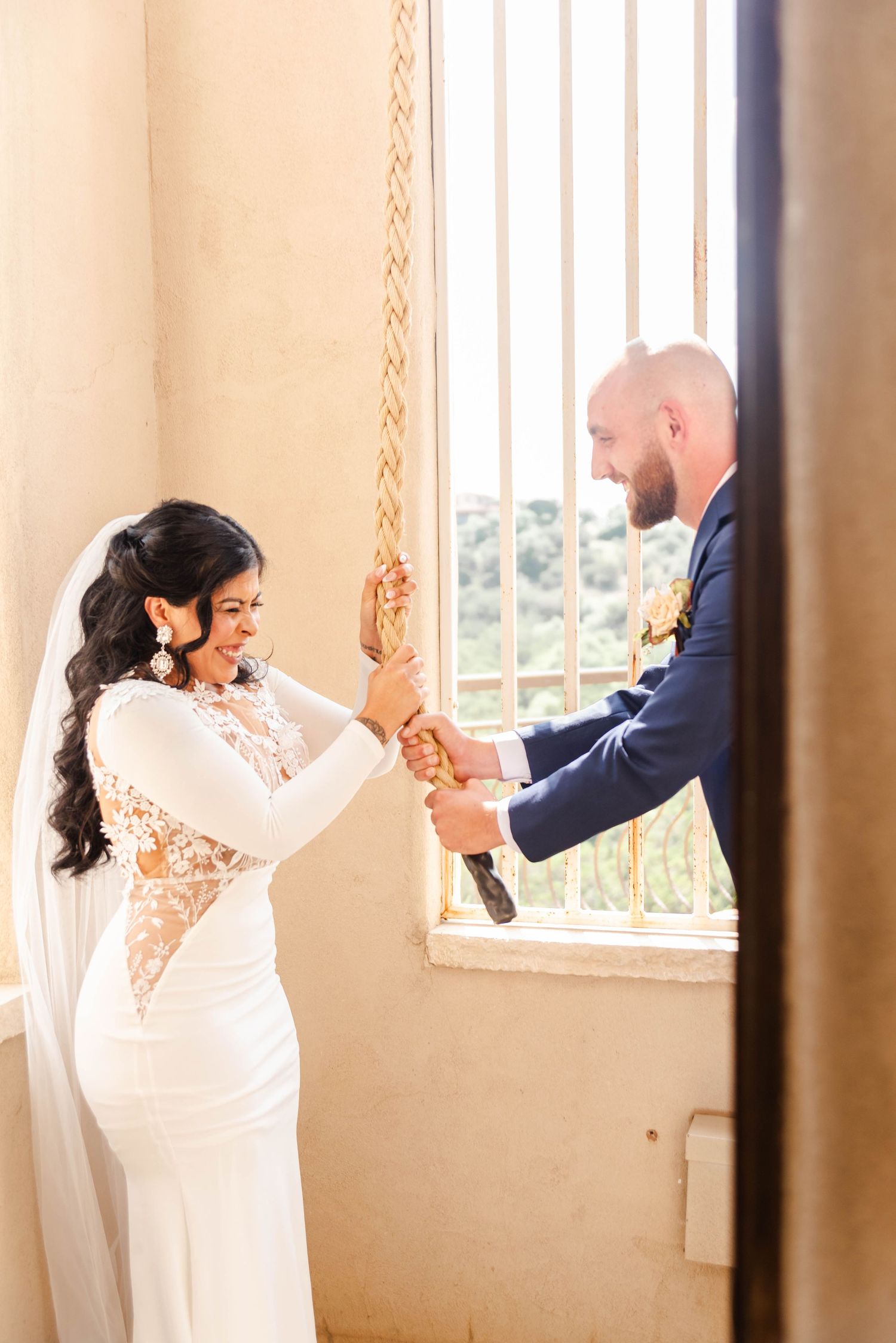 a couple ringing a bell together after their wedding