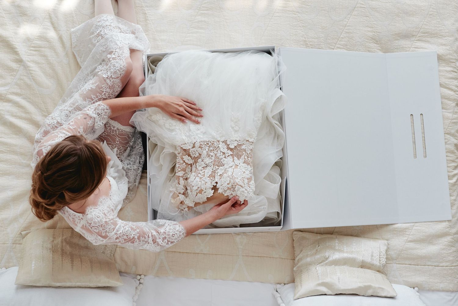 Bride touching her dress in the box