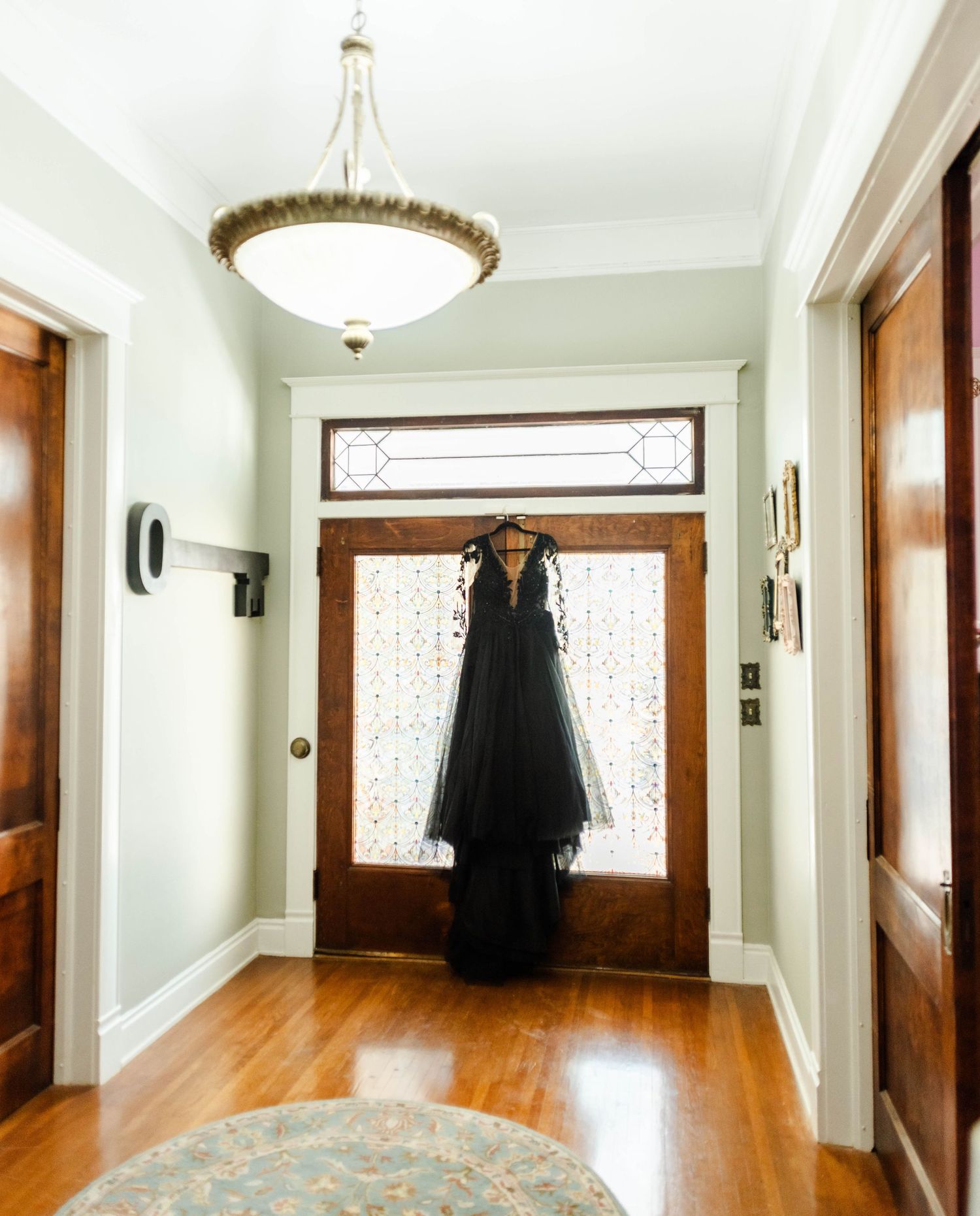 Black wedding dress hanging from door