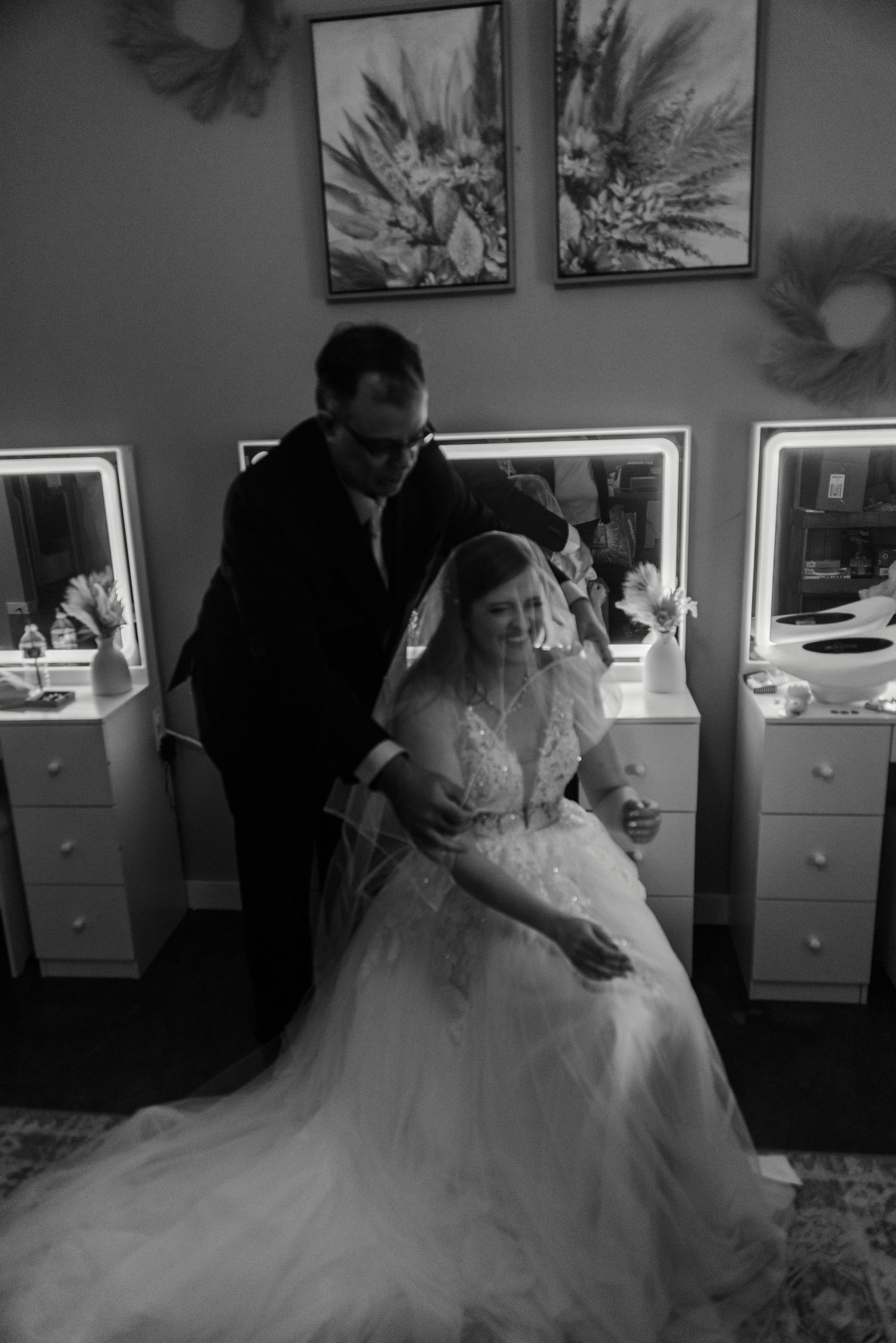 a father adding a veil to his daughter's wedding attire