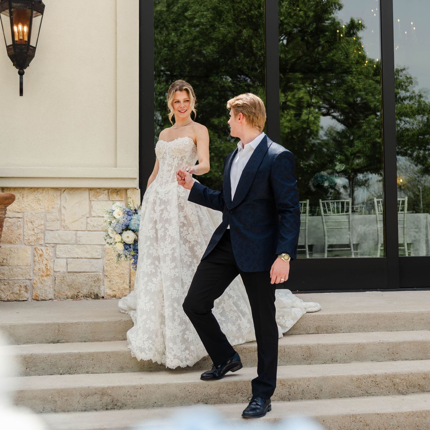 couple at the stairs between the patio and reception space