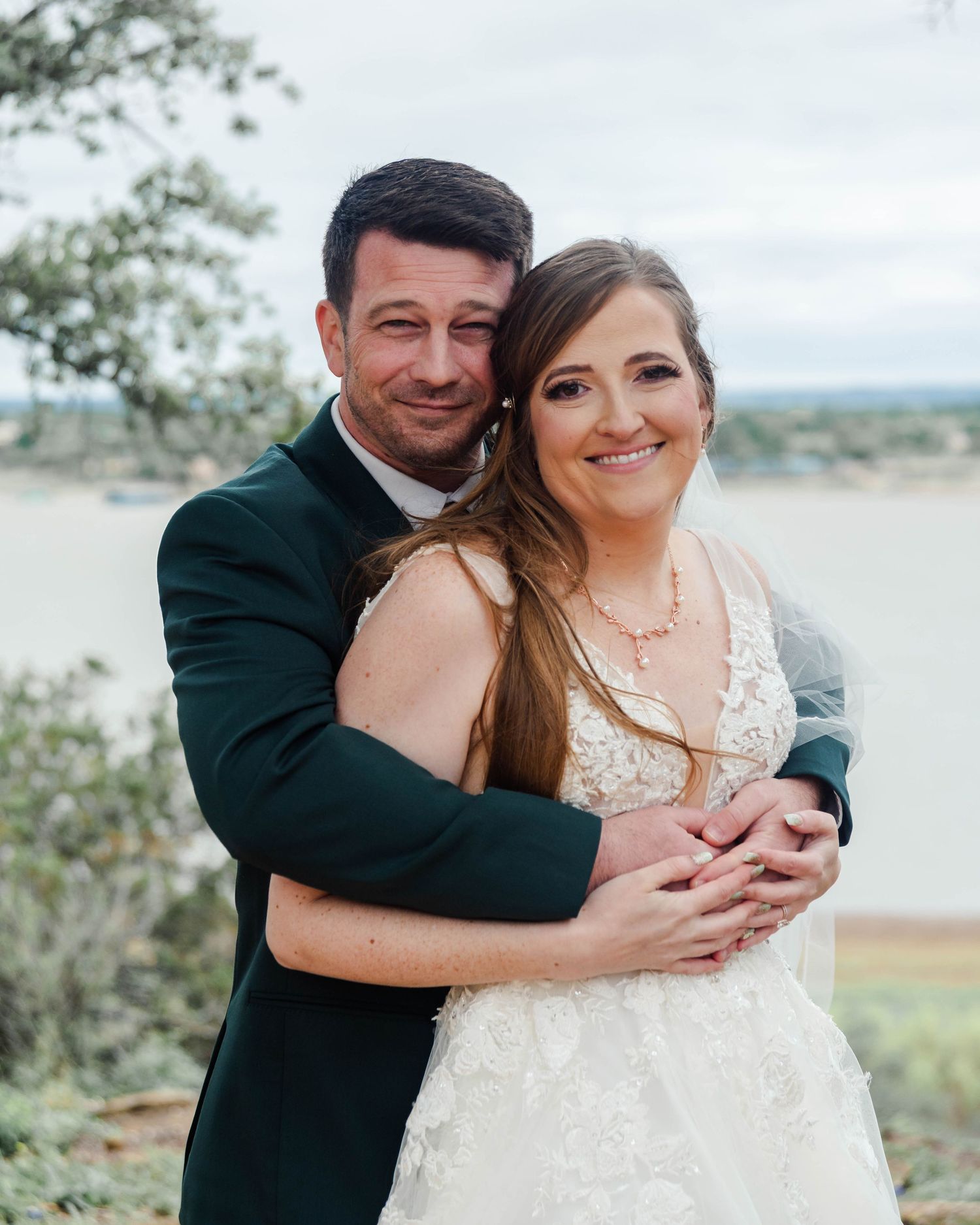 a groom wraps his arms around his bride
