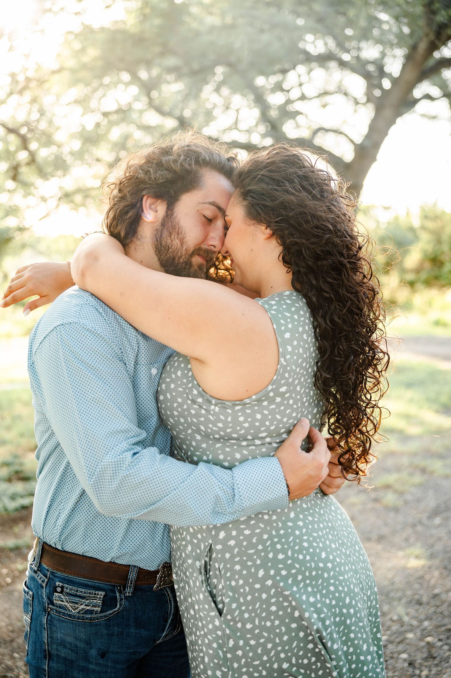 a couple embraces softly with their eyes closed