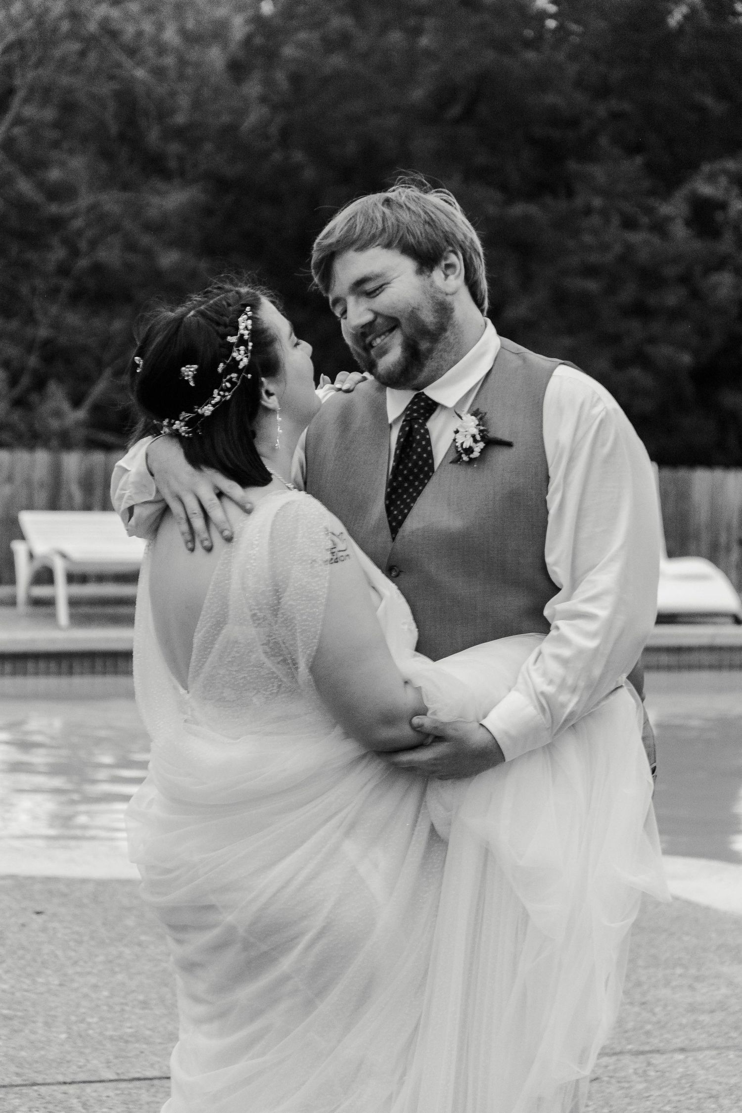 A couple dances in front of a pool