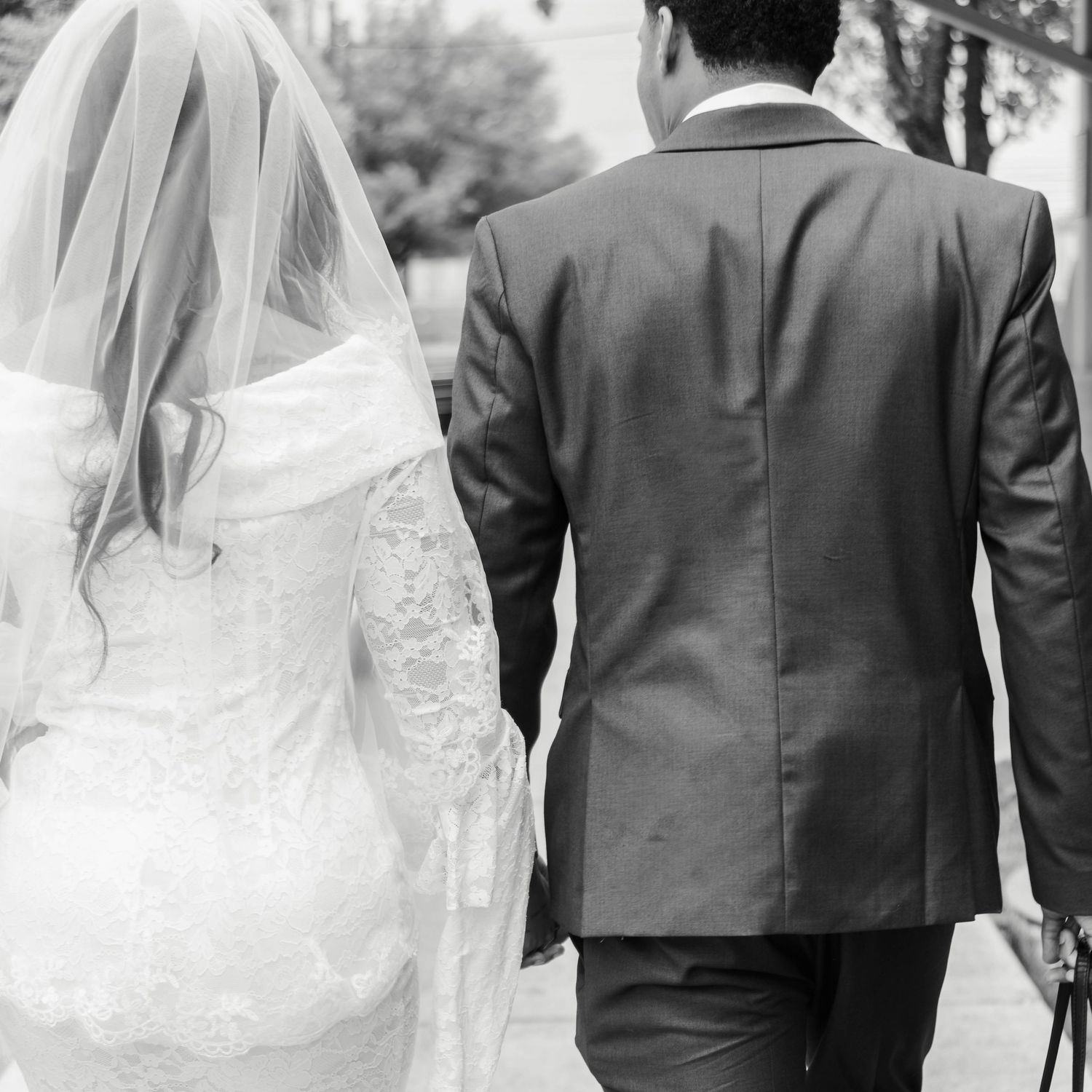 a couple holds hands while walking