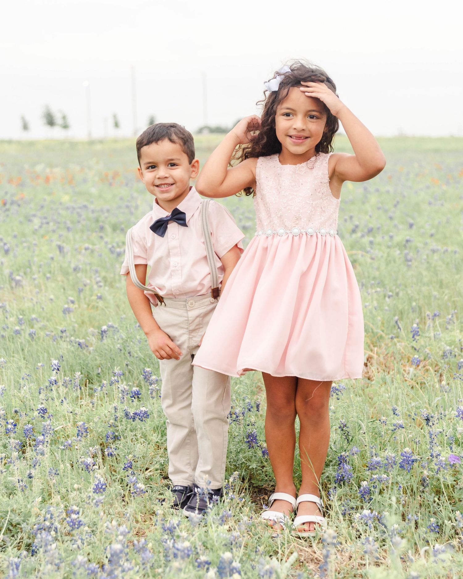 children standing in bluebonnets