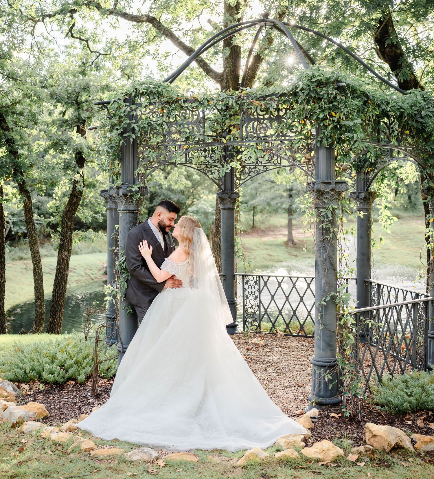 a couple stands at a gazebo