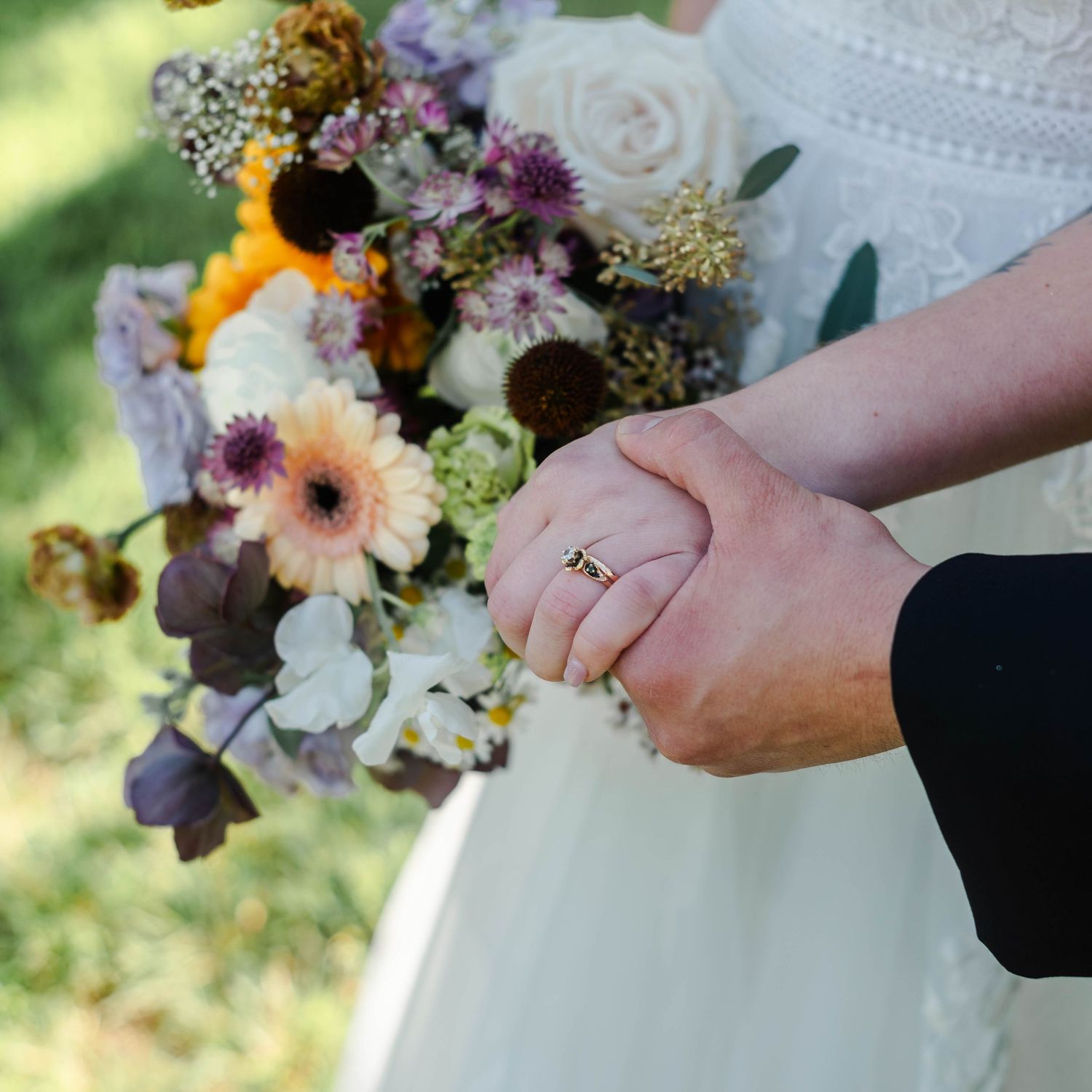 Bride and Groom holding hands with a bouquet