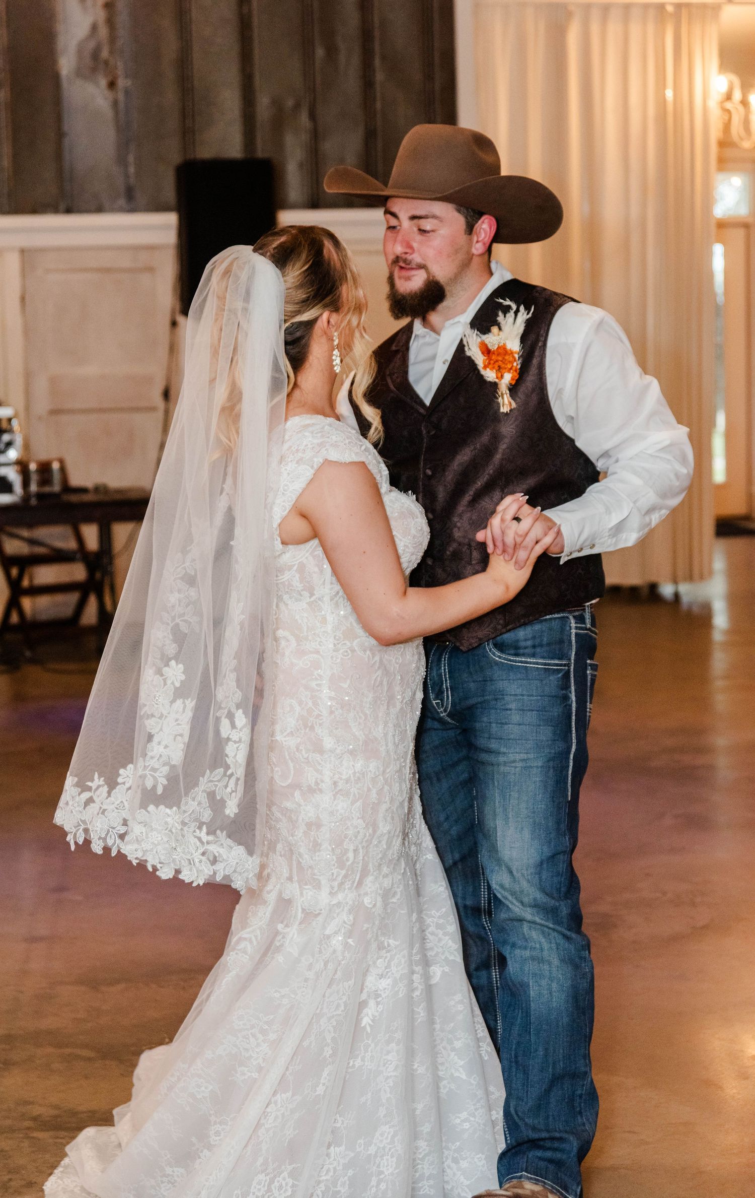 A bride and groom dances together at their wedding