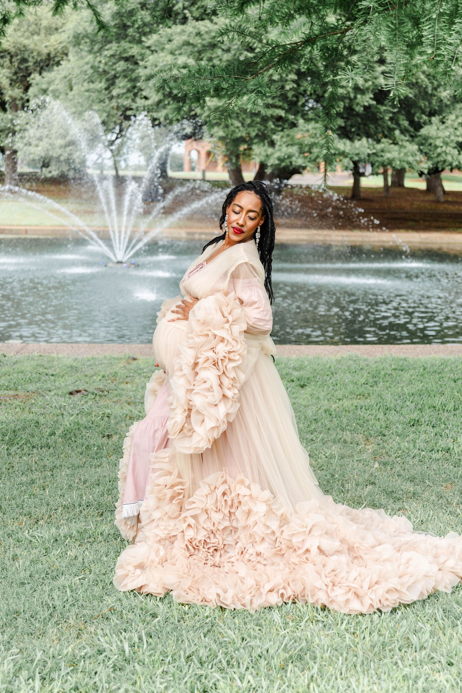 A woman poses holding her baby bump for a photo