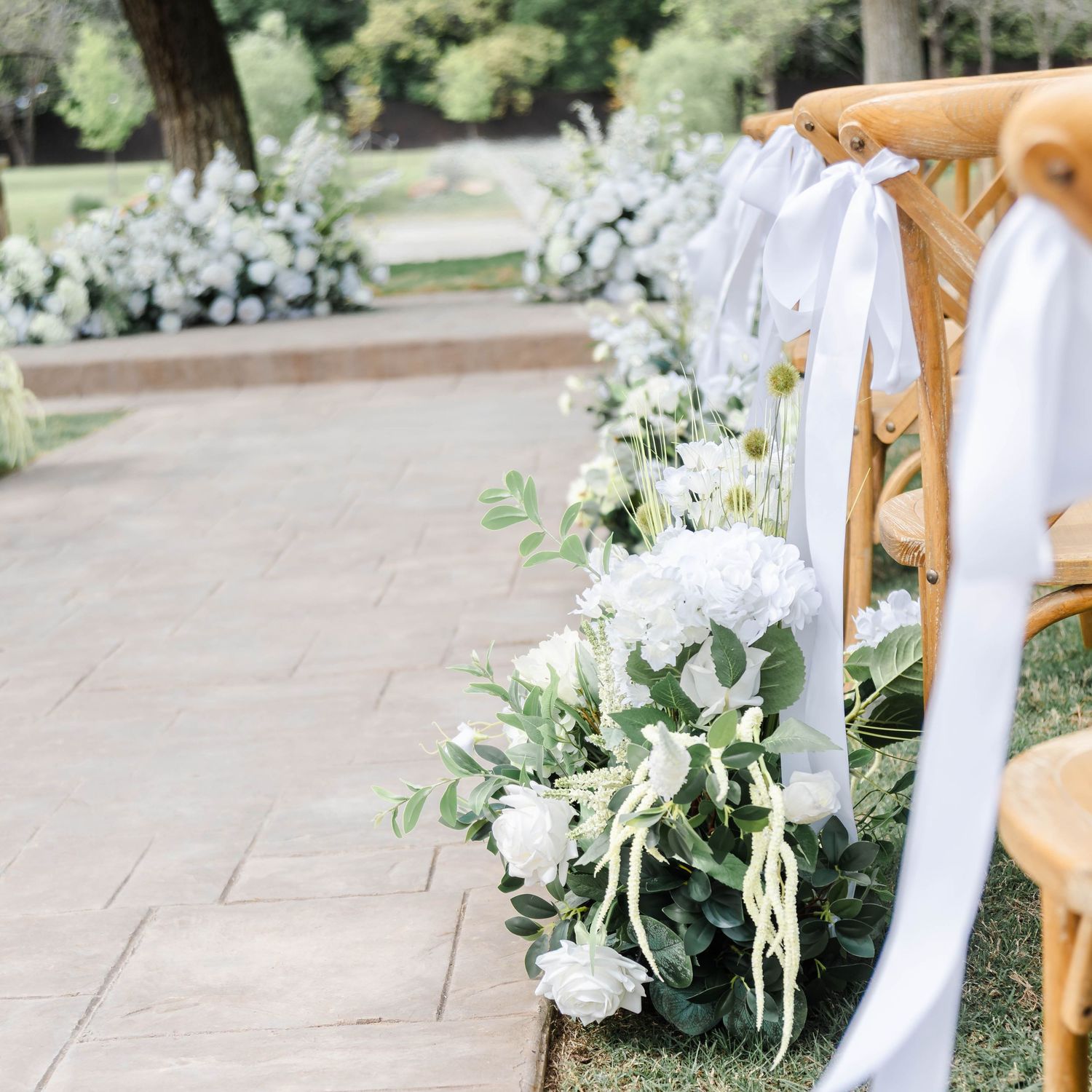 details of chairs with ribbon and white florals