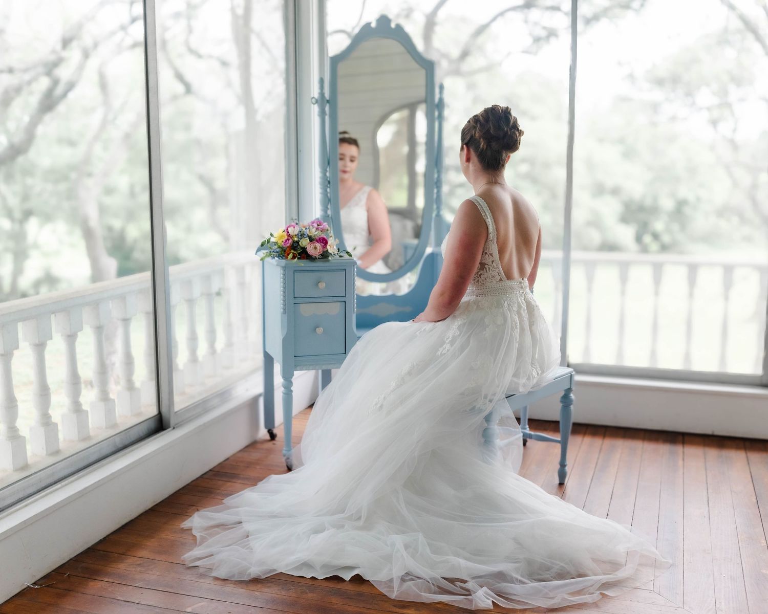 a bride looks at herself in a mirror