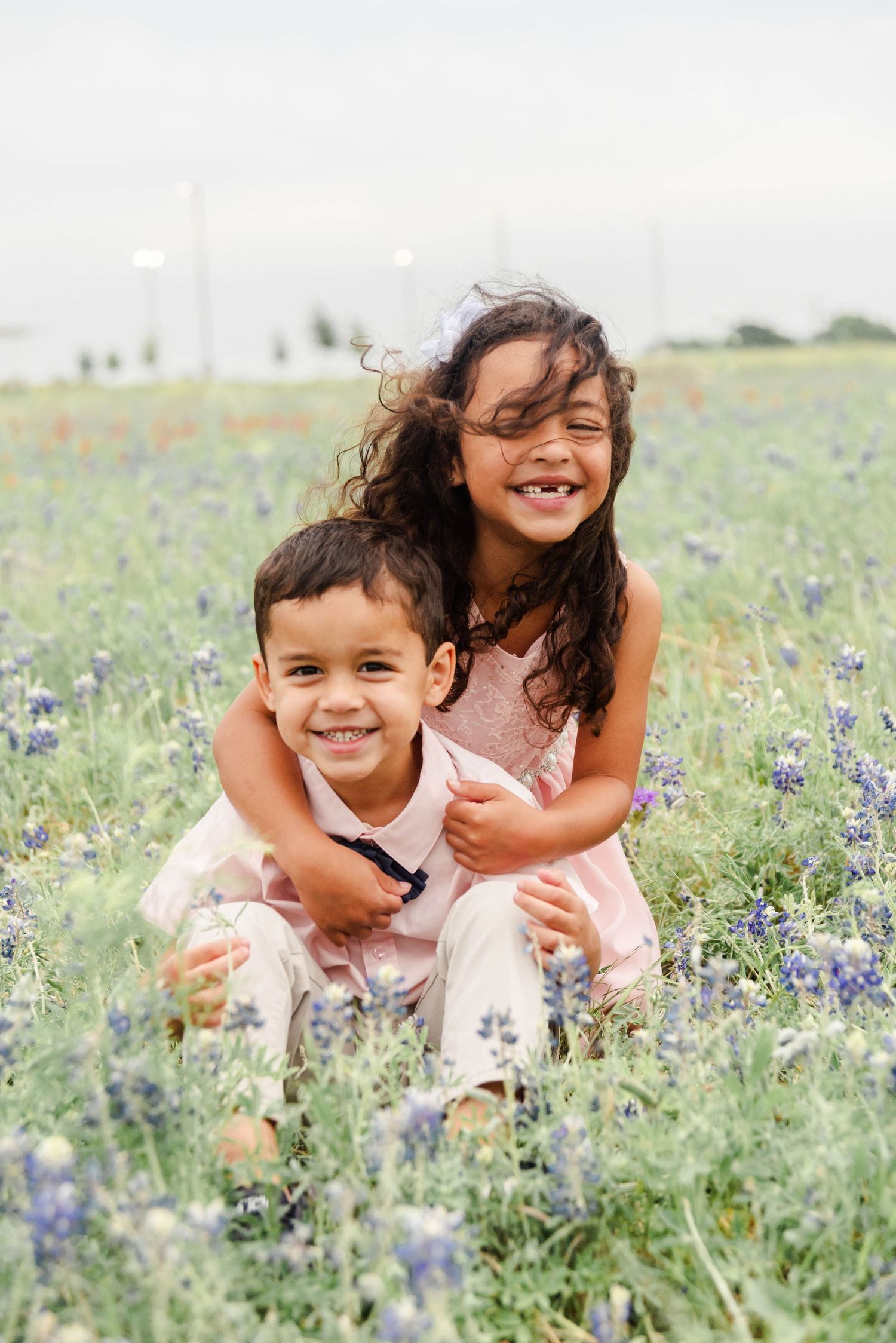 children playing in bluebonnets