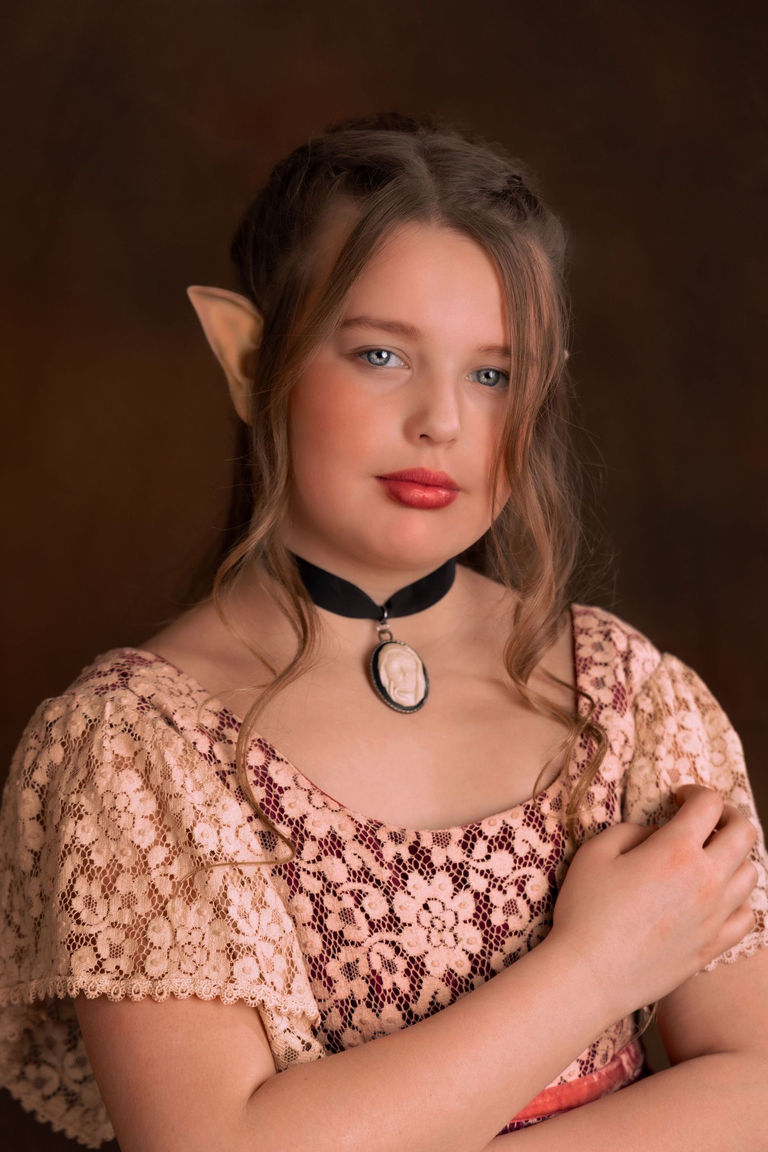 fantasy headshot portrait of young blonde girl with long curls wearing antique jewelry red dress with white lace and elf ears