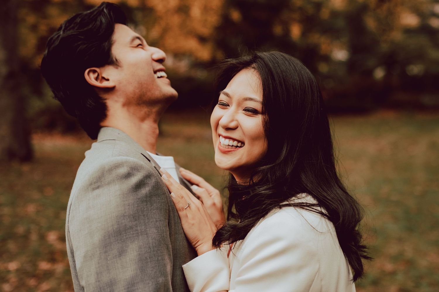 newly engaged couple laughing during their engagement session in central park