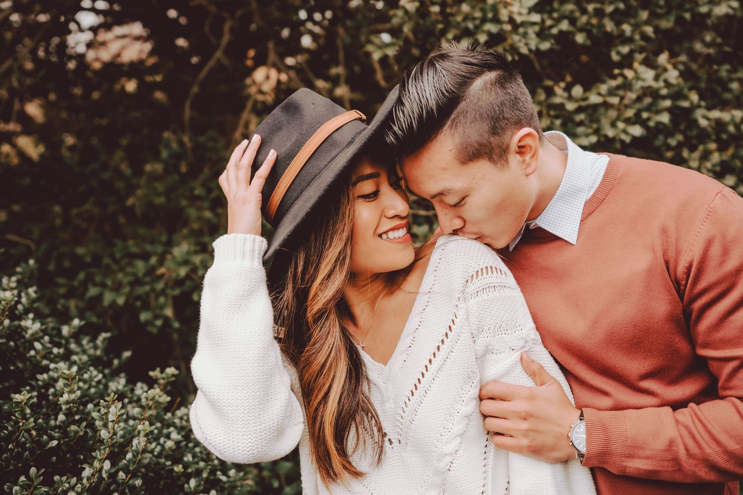 couple having intimate moment during engagement session at plantingfields arboretum