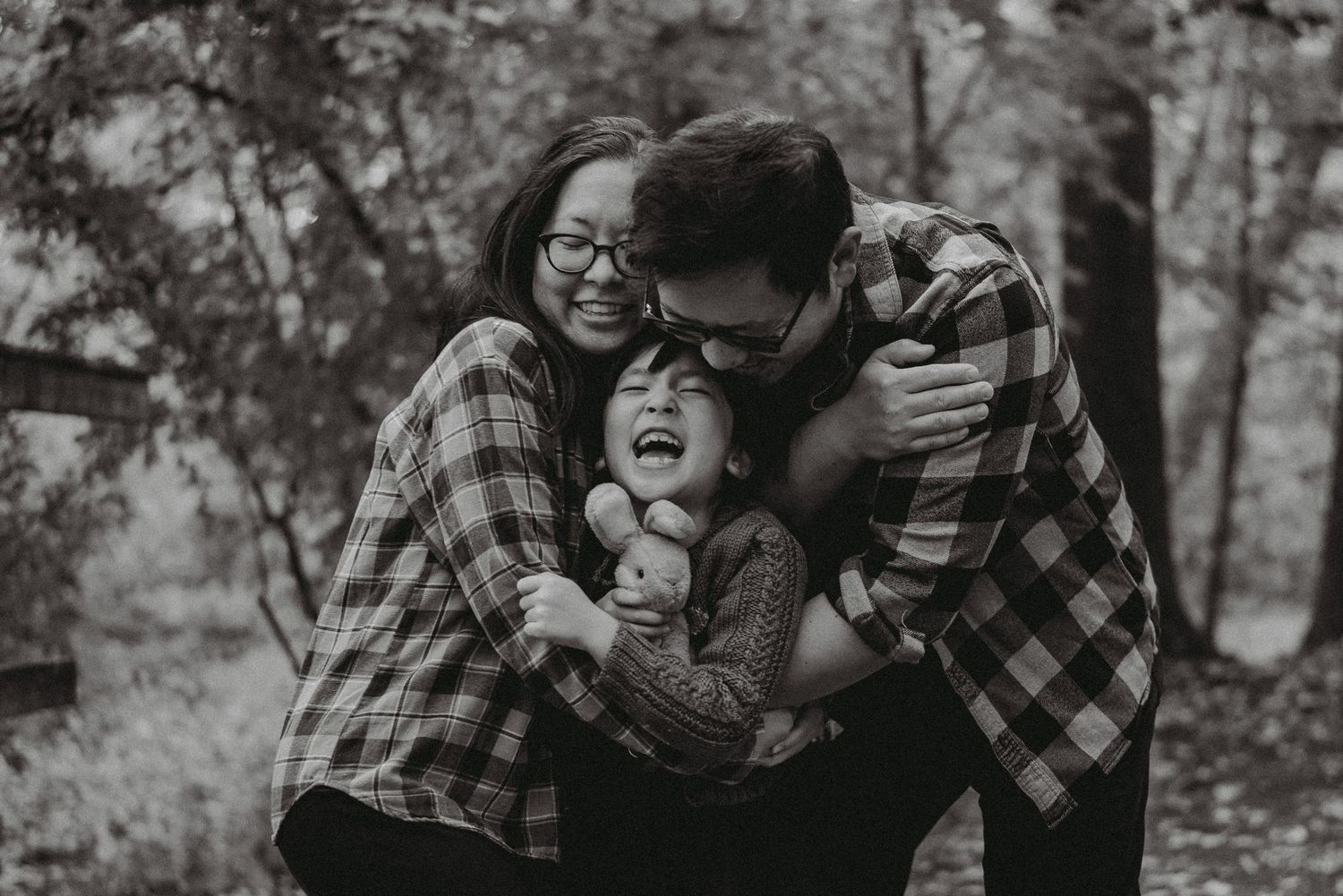family photo of the owner of Heartfelt Studio hugging his wife and child