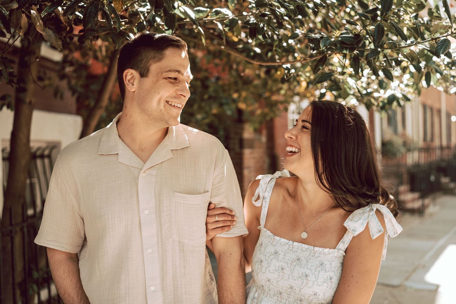 couple smiling naturally standing next to eachother