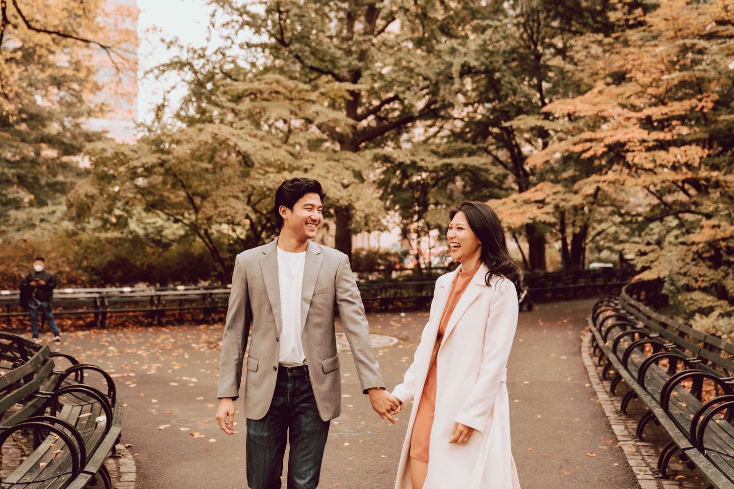 couple walking hand in hand during their engagement session in central park