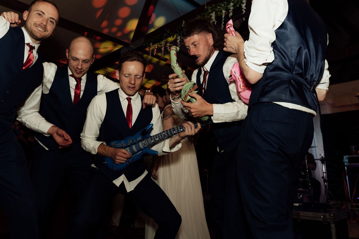 Wedding guests dancing and celebrating at the evening reception