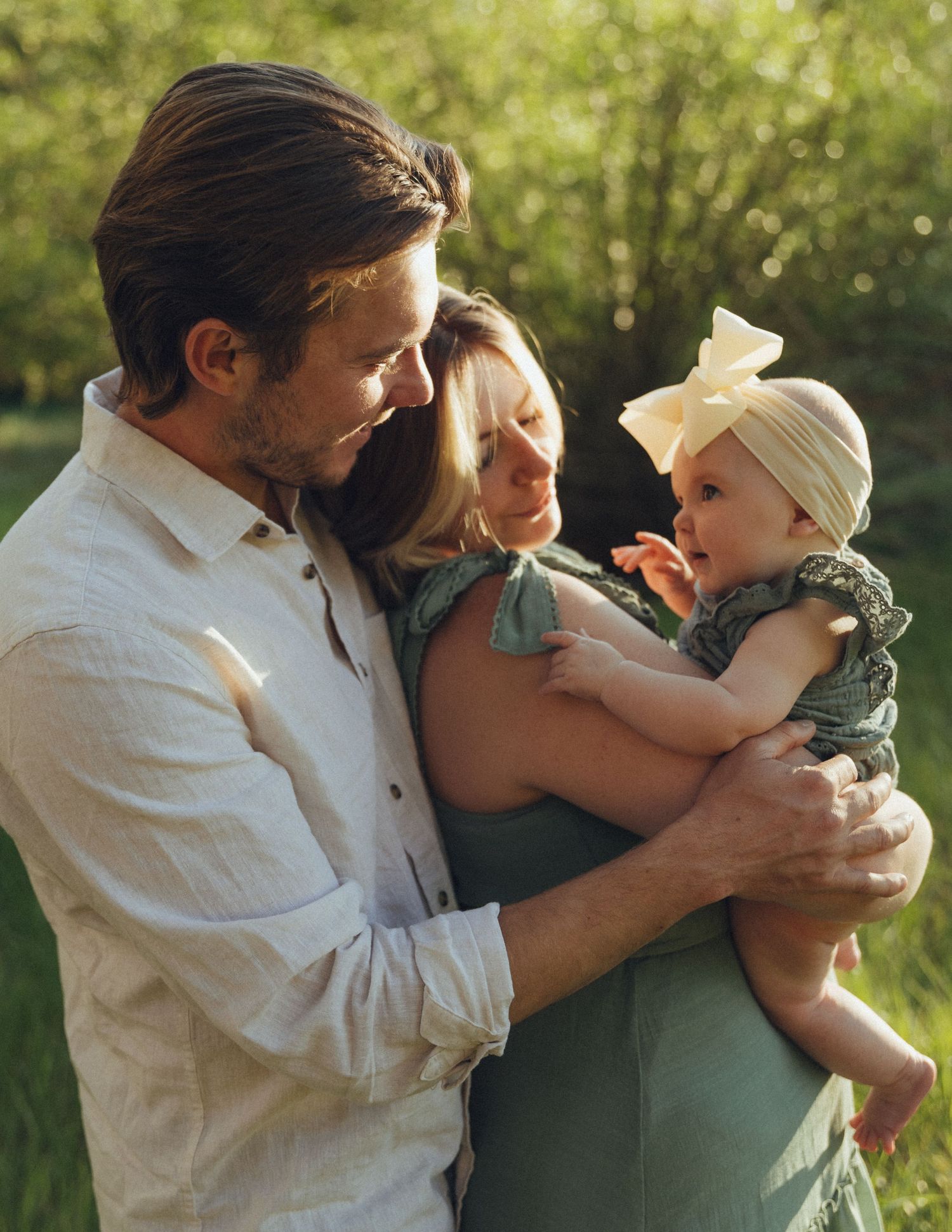 Man, woman, and baby embracing each other in a heartfelt family moment, sharing love and connection