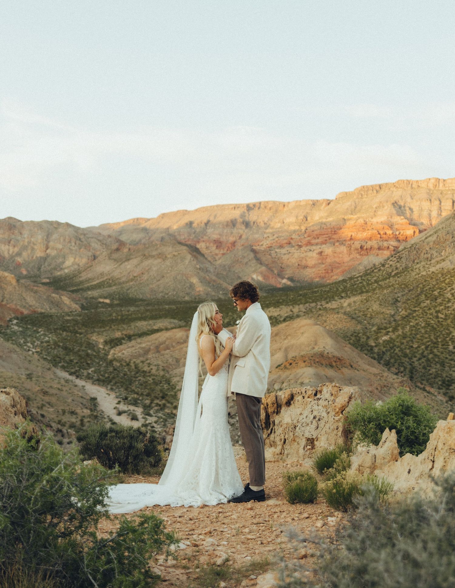 Couple eloping against a stunning desert backdrop, exchanging vows in an intimate and romantic setting.