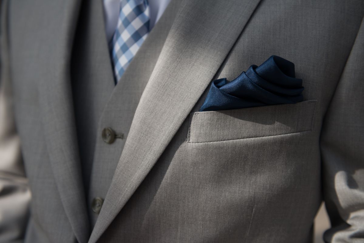 A dapper groom is photographed in his three piece suit on his wedding day in Lake Placid, NY, by wedding photographer Kevin Young.