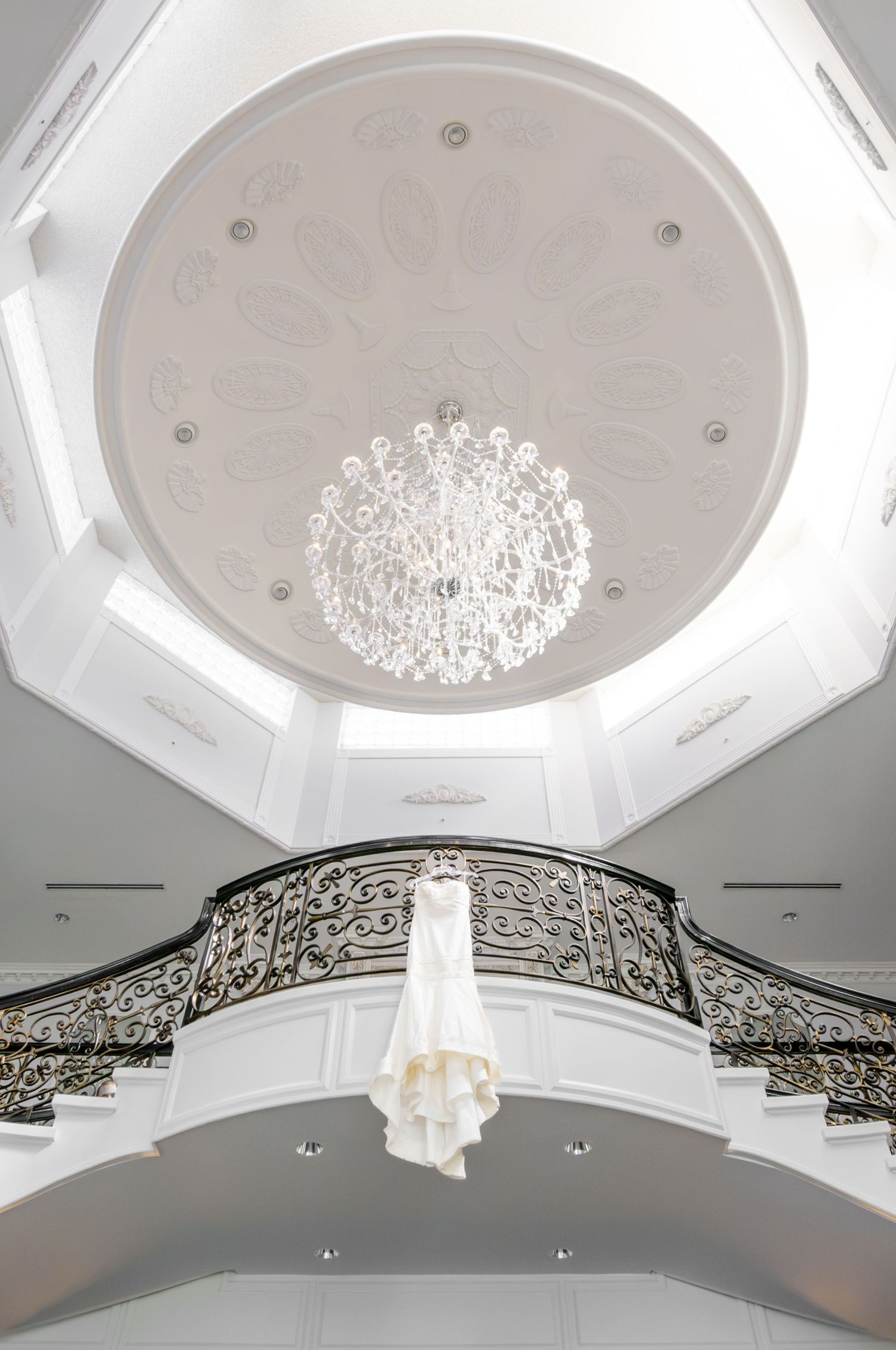A couture wedding gown is photographed in the gallery of a luxurious Adirondack wedding venue