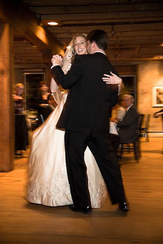 A bride and groom from upstate ny are photographed by Kevin Young during their first dance in a rustic Adirondack weddin