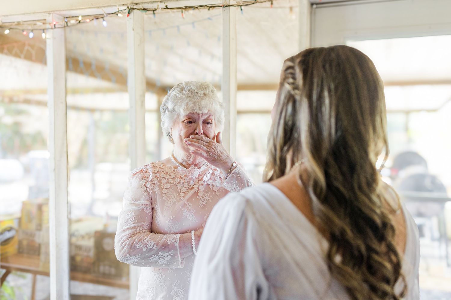 A series of bridal preparation photos showing a wedding dress being fitted and styled in a bright, airy room.