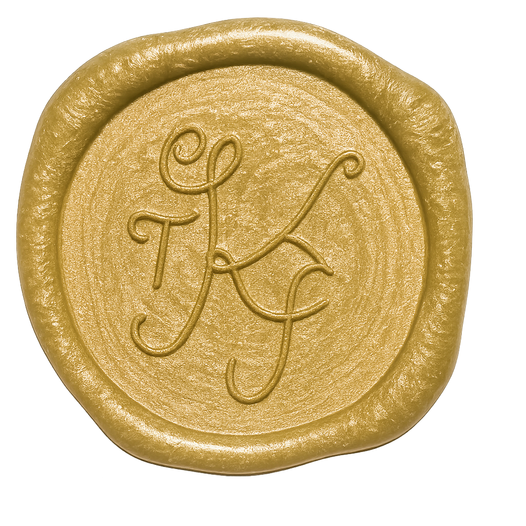 Four gold wax seals with decorative monogram designs arranged in a row on a white background.