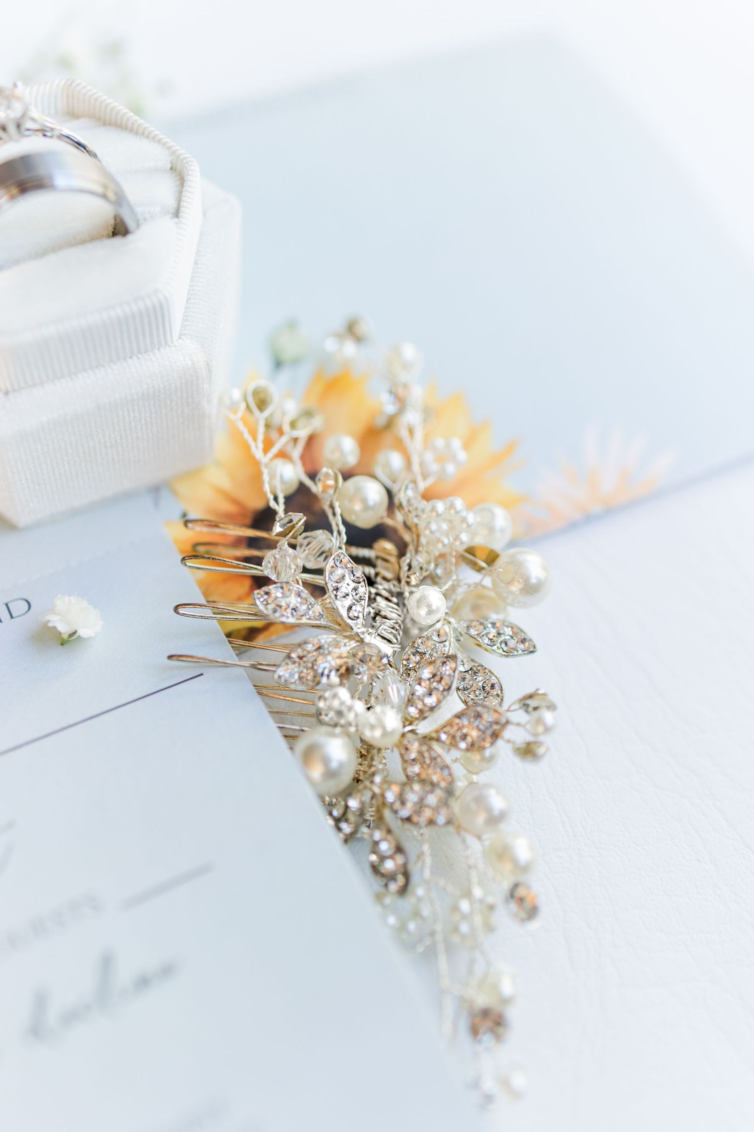 A delicate bridal hair comb featuring pearl and crystal floral details photographed from multiple angles on white surface.