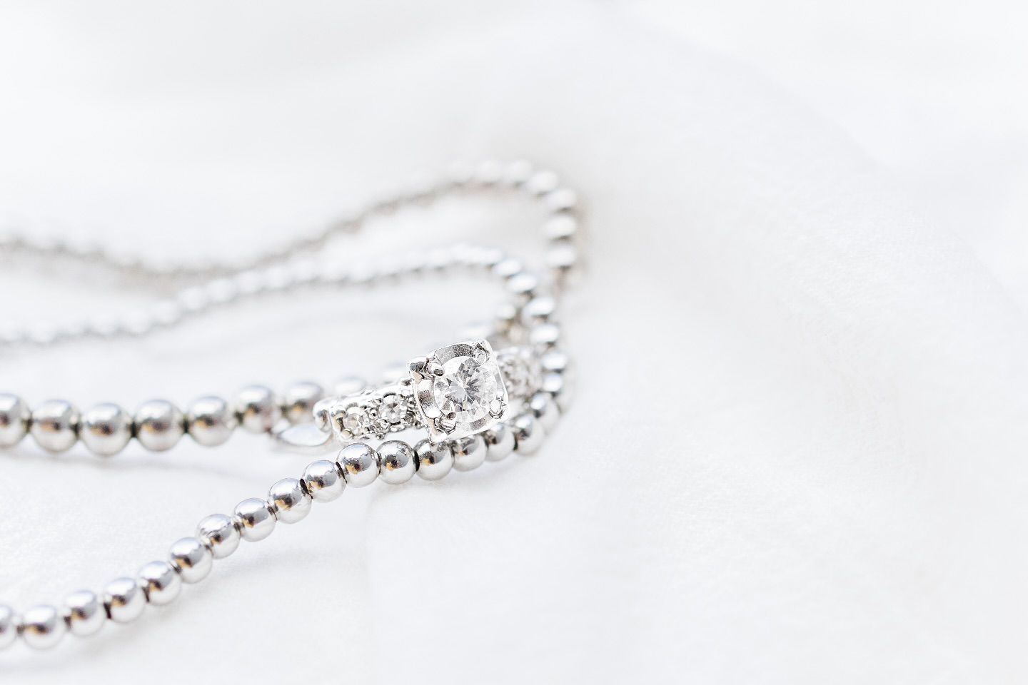 Elegant silver tennis bracelet with sparkling cubic zirconia stones arranged in a delicate line formation.