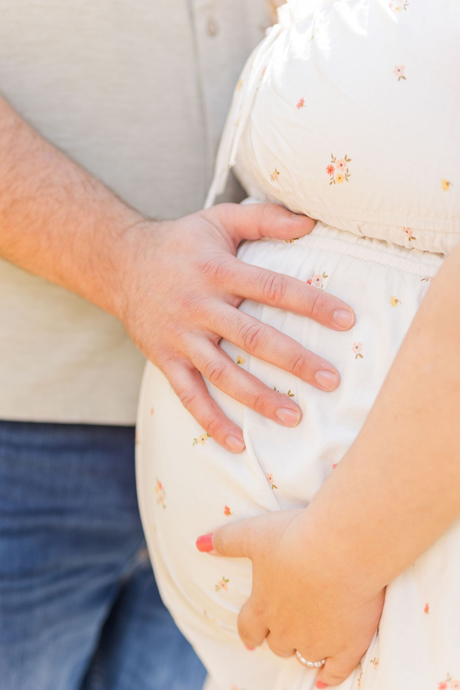 Hands gently holding and caressing a pregnant belly in a series of close-up photos against a light background.