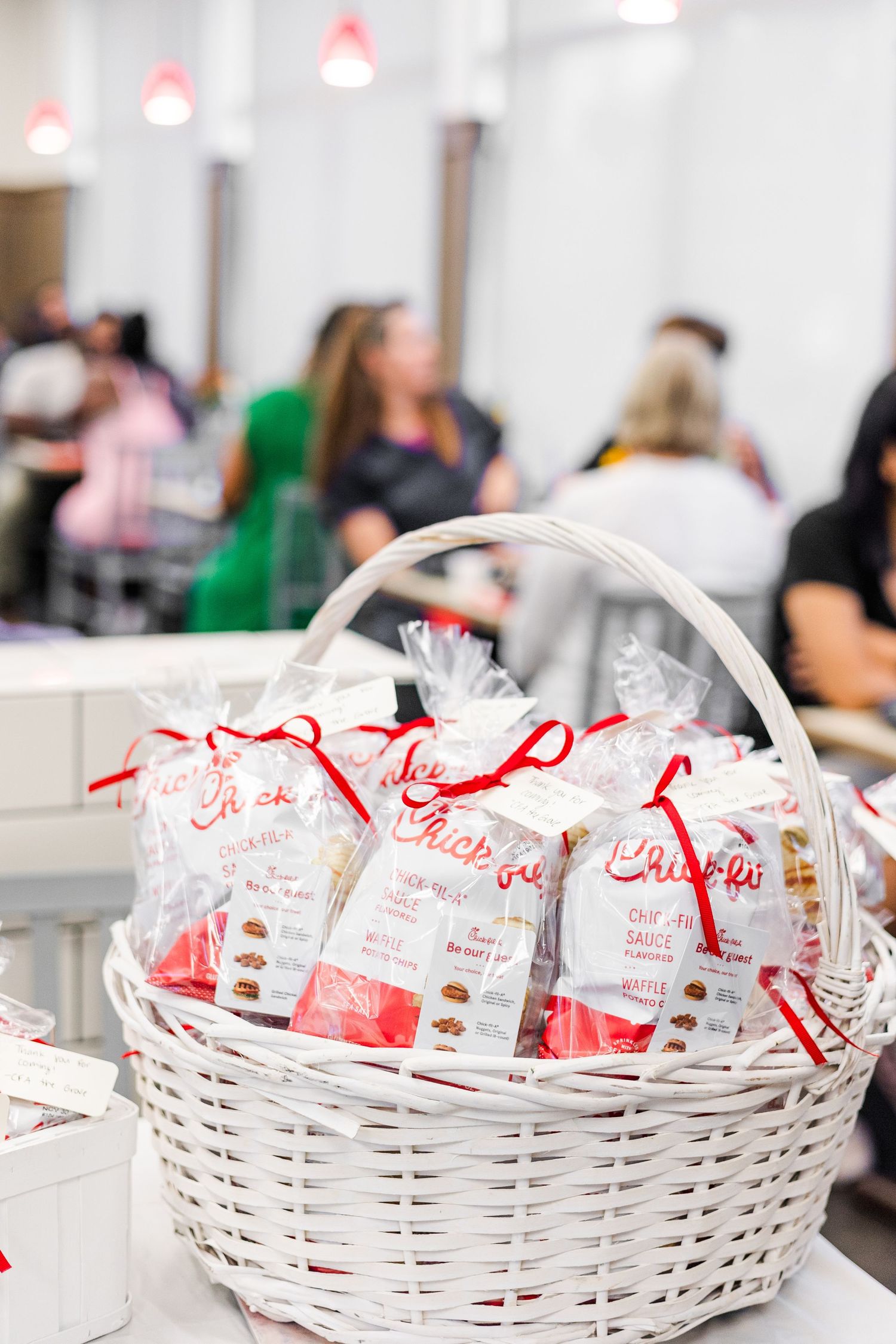 White wicker baskets filled with Chick-fil-A sandwich bags are displayed in a row on a counter.