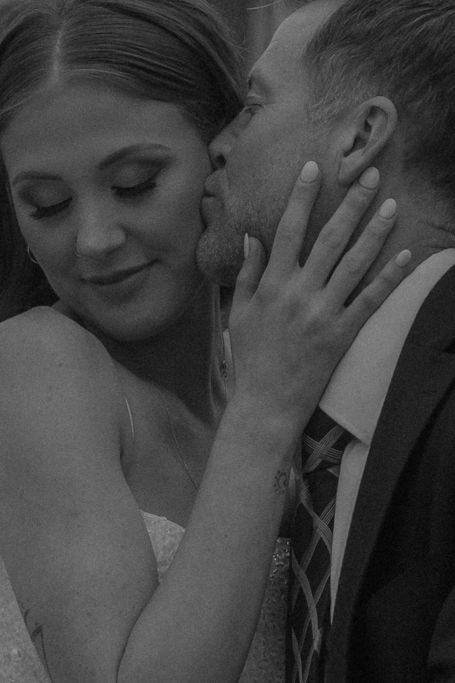 A romantic black and white series of wedding photos showing an intimate moment between a couple in formal attire.